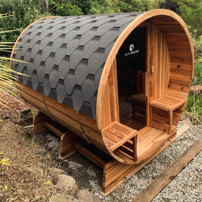 Barrel sauna set up in residential yard with professional electrical connection