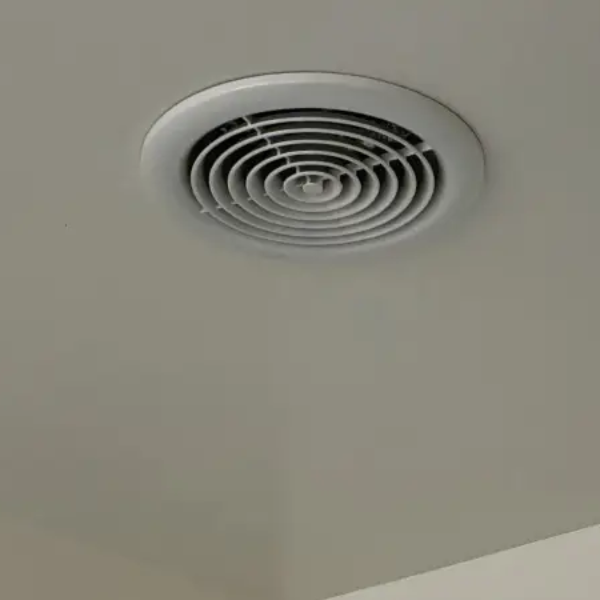 Ceiling-mounted bathroom extractor fan grille in Christchurch home
