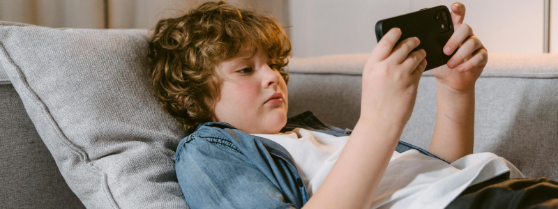 Kid viewing live security footage on phone – Easy Electrical Christchurch CCTV setup