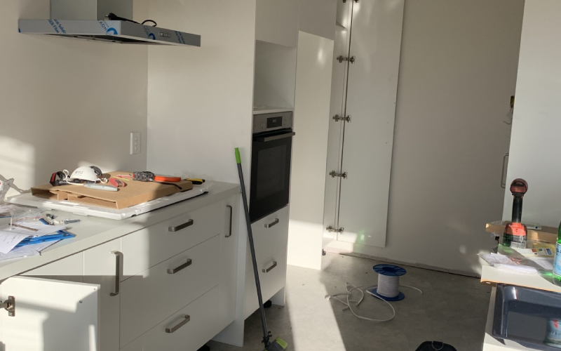Electrician fitting off power points and lighting during kitchen renovation – Christchurch residential project.